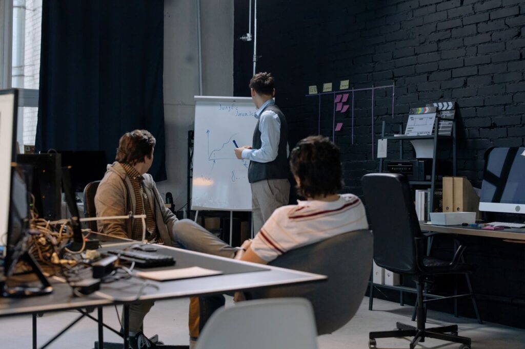 Business meeting with a presentation on growth charts in a contemporary office setting.